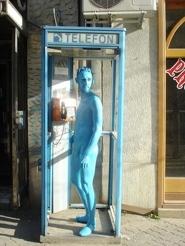Street theater by the ilotopie company, the colored people goes around the world for more than 30 years. Here a blue character in a blue telephone booth. Mister Gael Rodier is performing.
