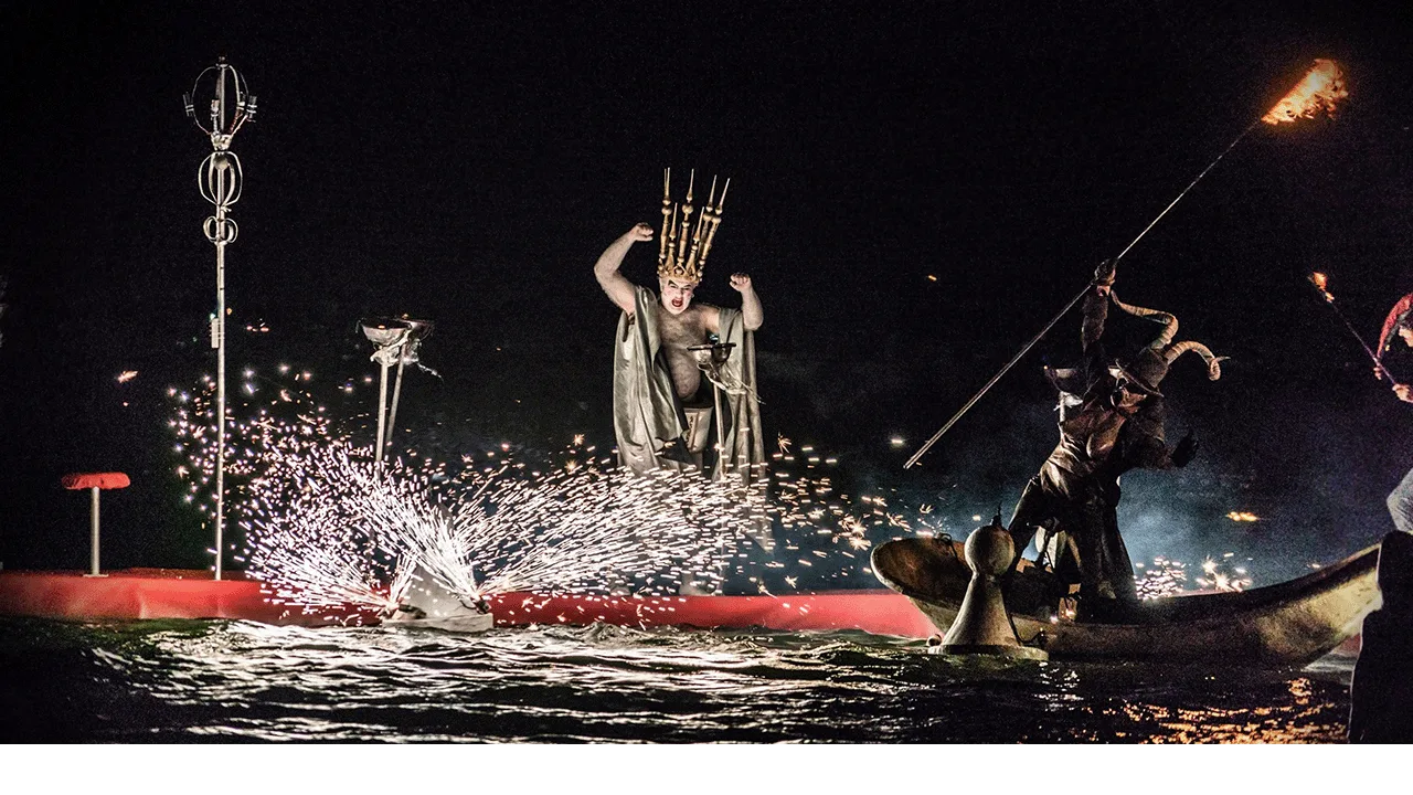 Big water show on the water by the ilotopie company, here the naked king on a red floating carpet fire works on his leg coming from a floating pawn.