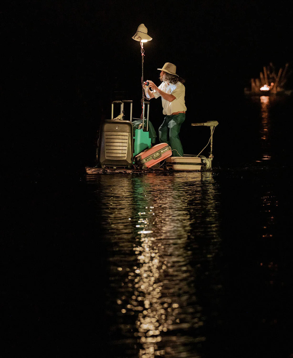 During the performance on the water the Extraodinary Journey : A man on a wave of water made of a suitcase takes photos. Here in Fos-sur-Mer.